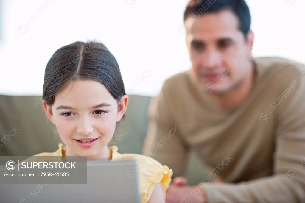 Daughter 8_9 and father using laptop