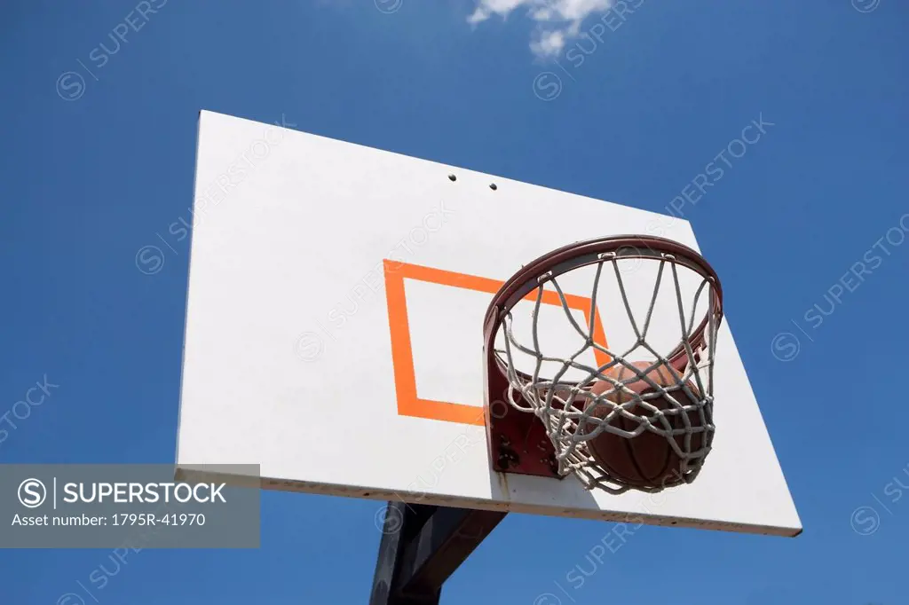 USA, Florida, Miami, Low angle view of basketball hoop with basketball inside