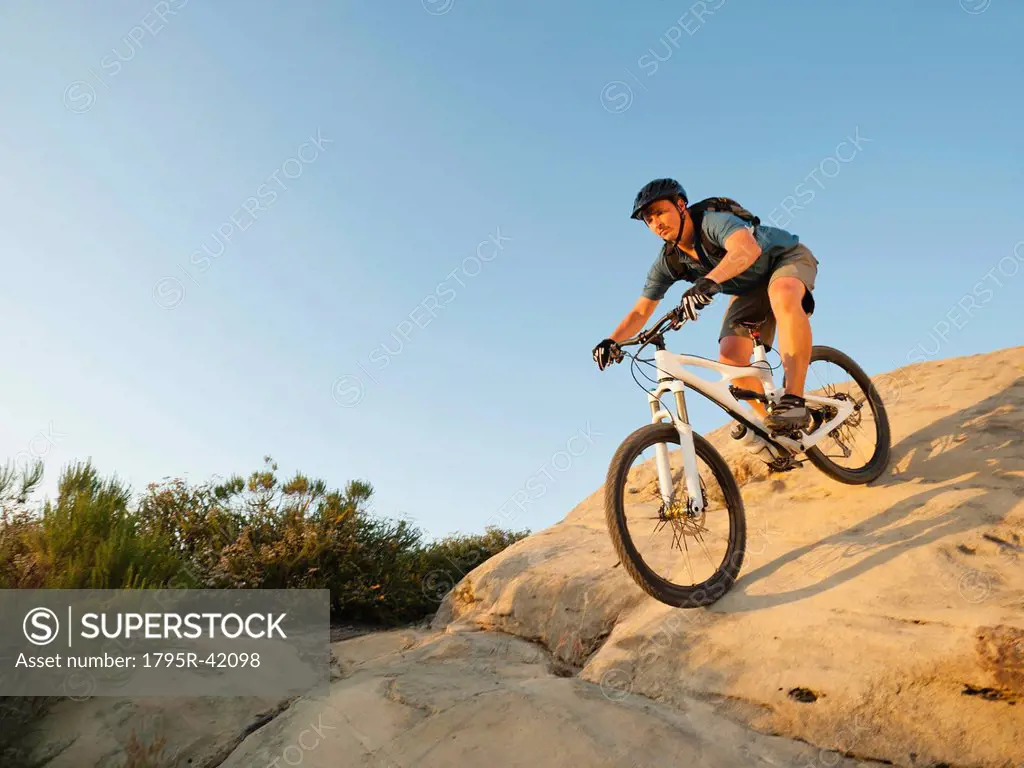 USA, California, Laguna Beach, Man cycling down hill