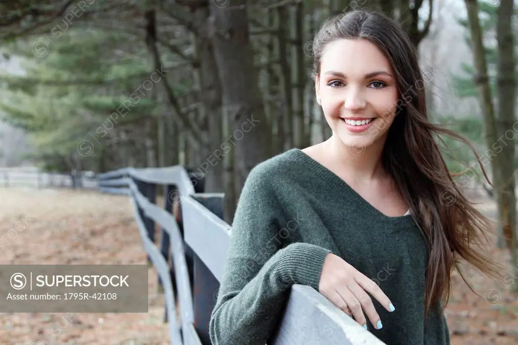 USA, New Jersey, Califon, Teenage girl 16_17 standing near fence and looking at camera, portrait