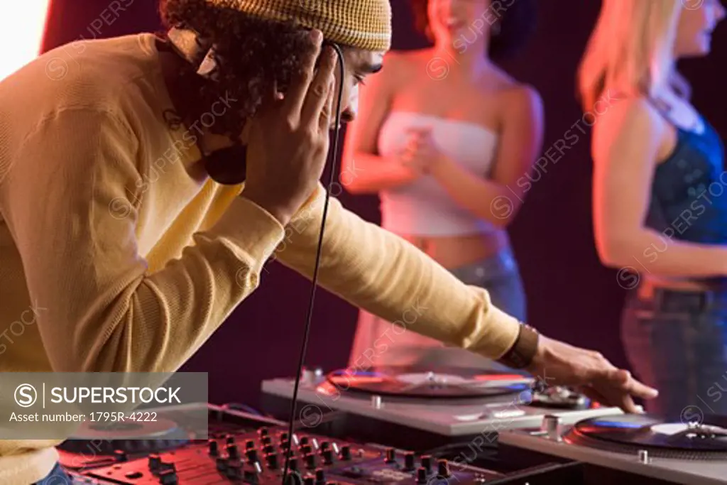 Young man playing music at a dance club