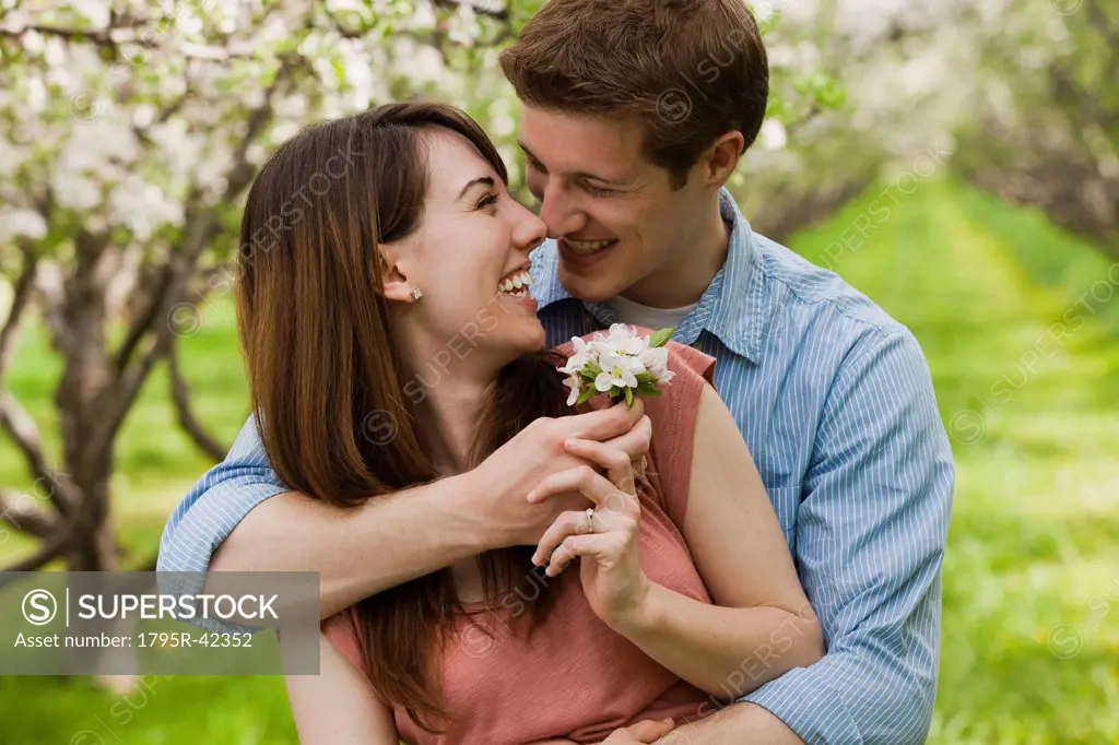 USA, Utah, Provo, Young couple with blossom in orchard