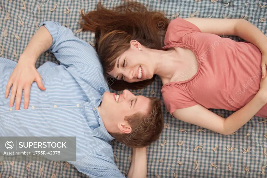 Young couple lying on blanket