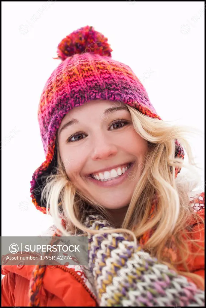 Portrait of young woman wearing winter clothes outdoors