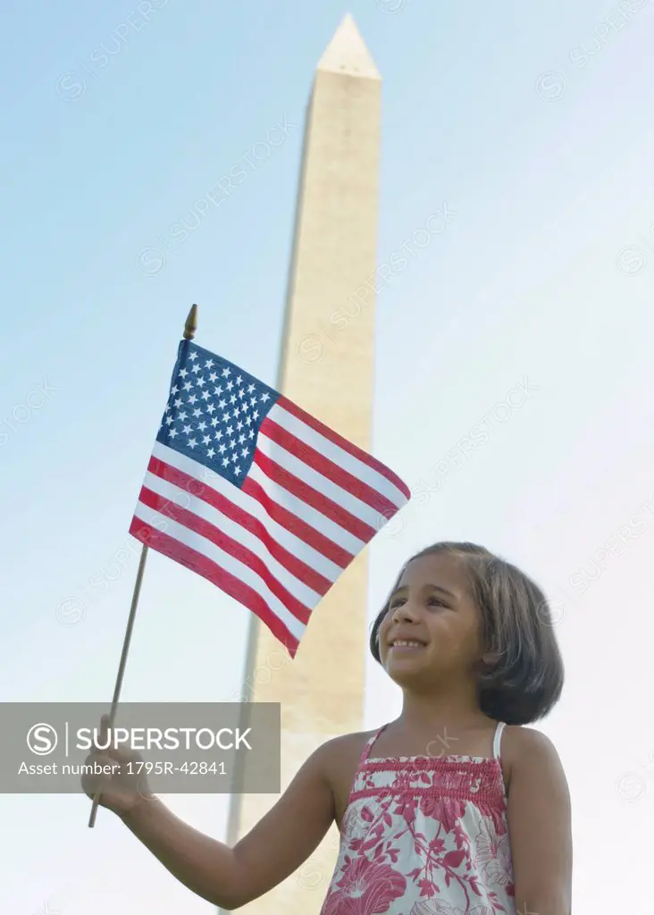 USA, Washington DC, girl 6_7 with US flag in front of Washington Monument