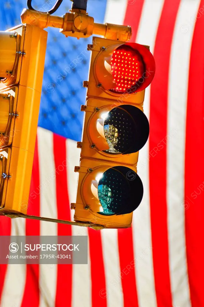 Traffic lights with american flag in background