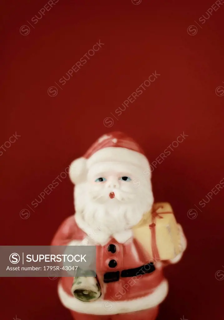 Father christmas figurine on red background
