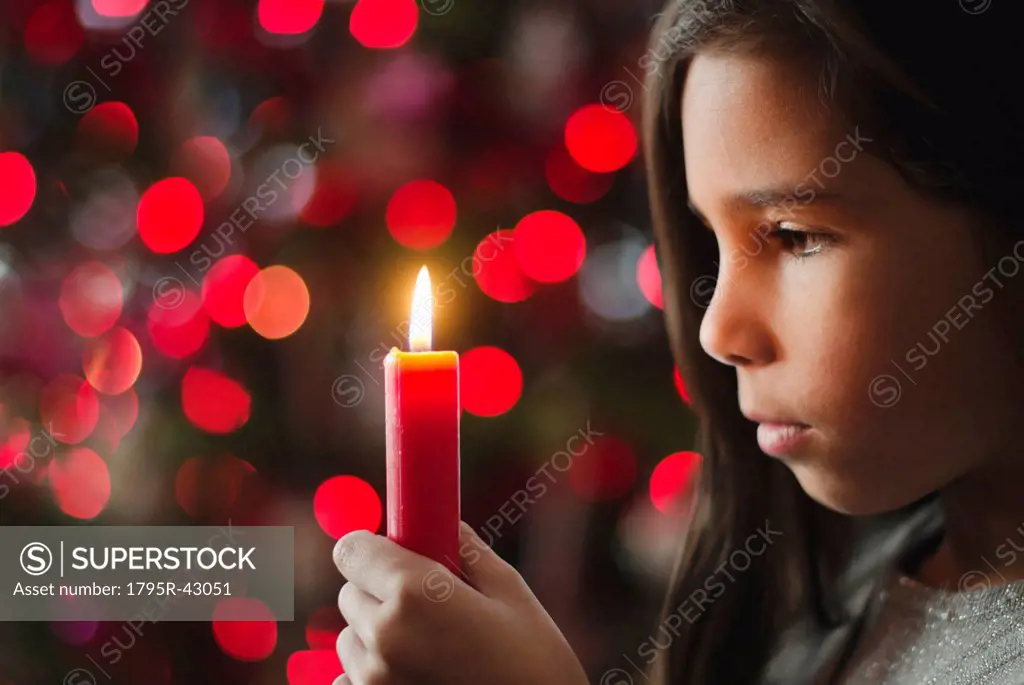 Girl 8_9 holding candle