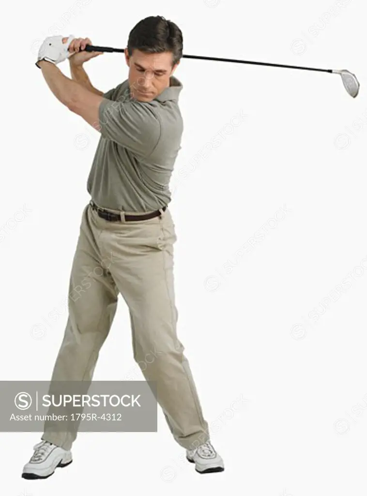 Studio shot of man playing golf