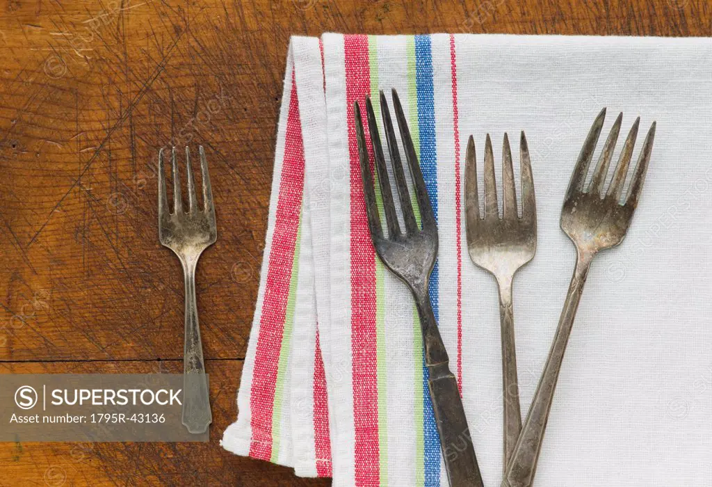 Close up of rusty silver forks and napkin