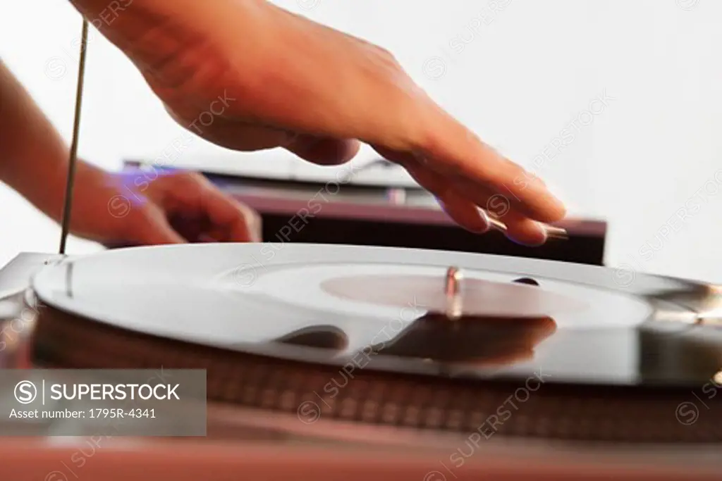 Person mixing sound from records