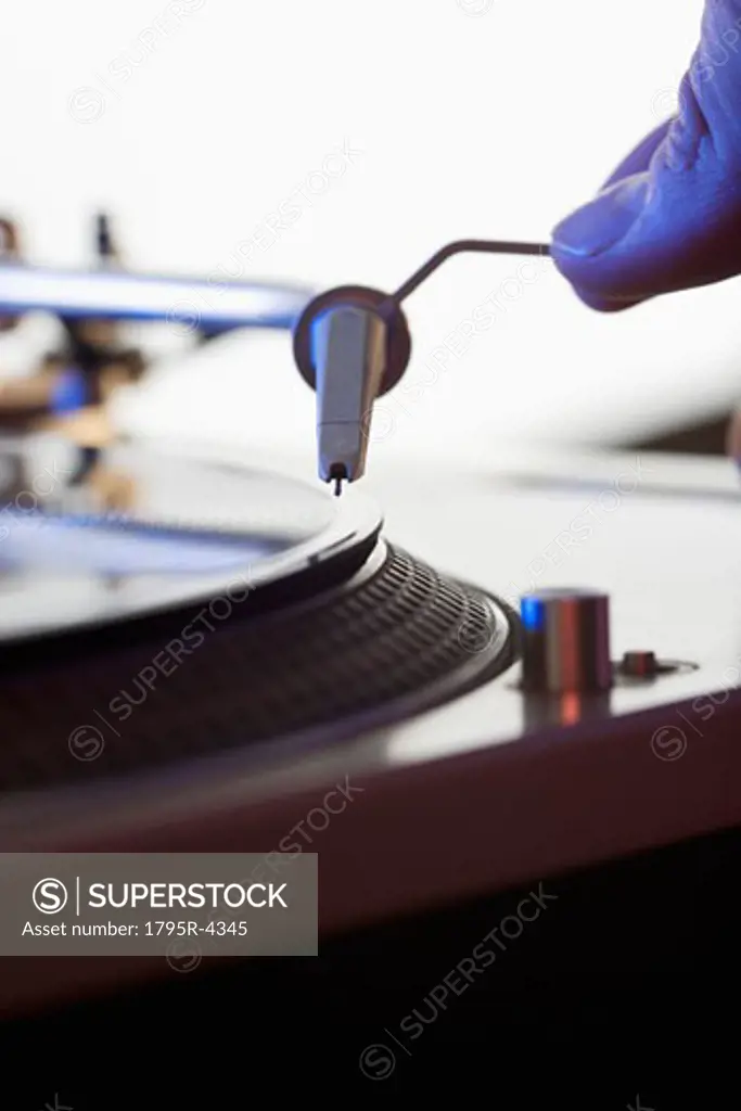 Person setting needle on a record