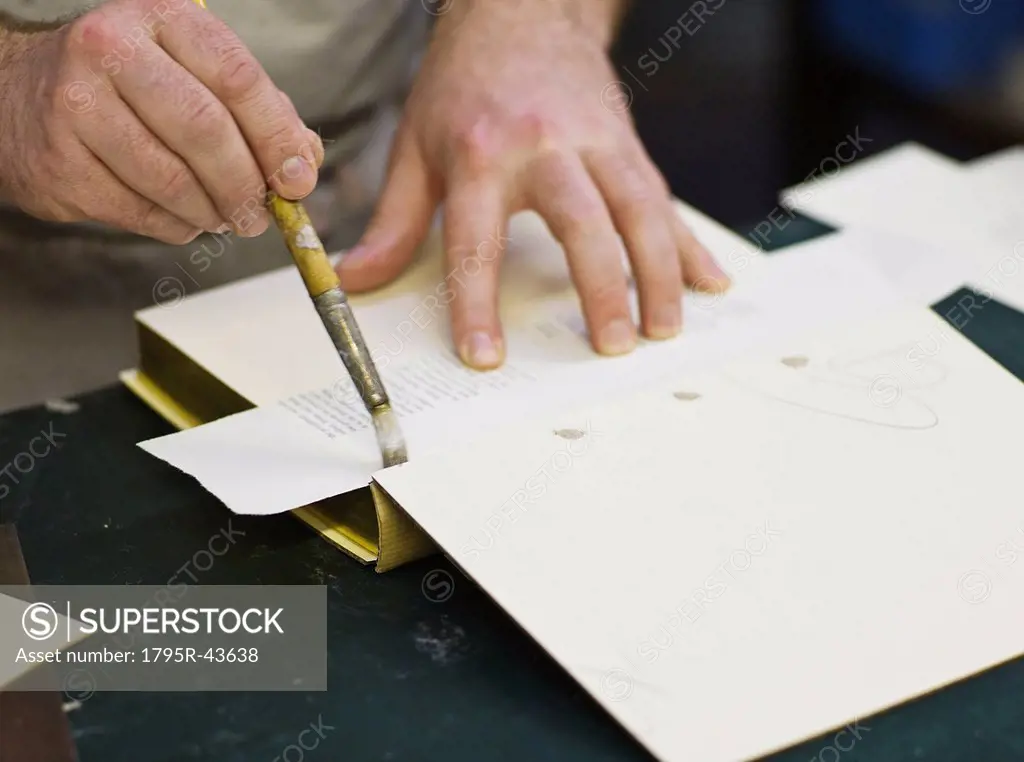 Craftsman making book bindings
