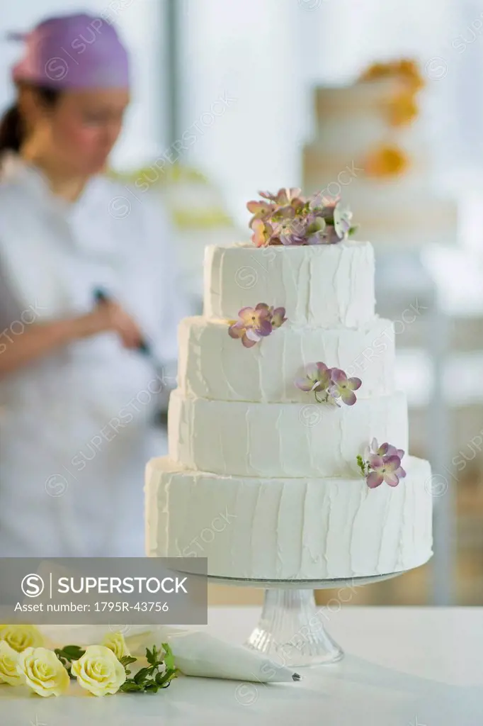 Wedding cake, pastry chief in background