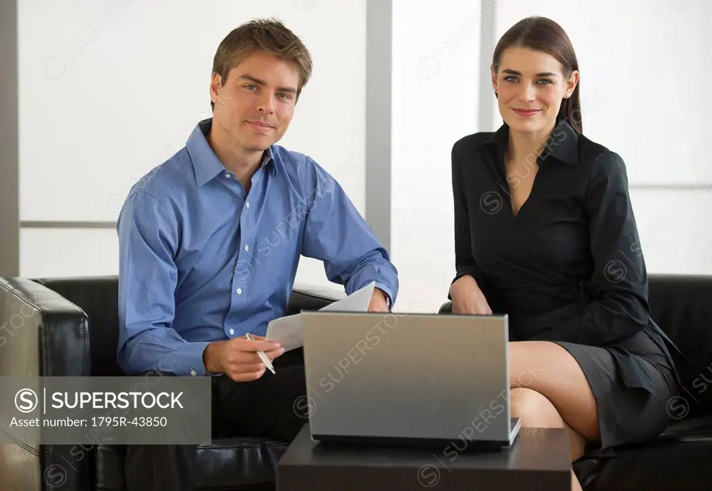 Pair of businesspeople working in office