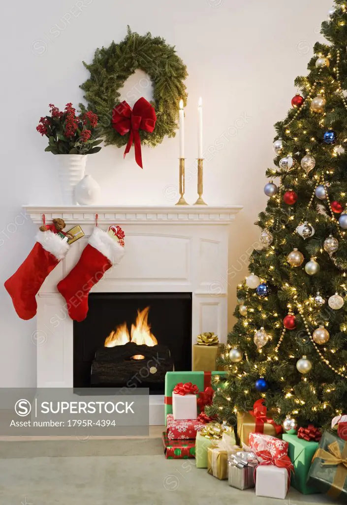 Christmas tree with presents and fireplace with stockings