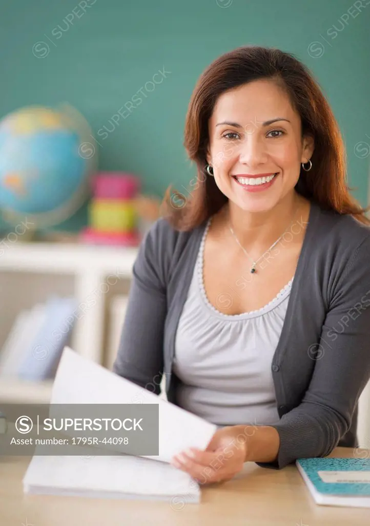 USA, New Jersey, Jersey City, portrait of smiling female teacher in classroom