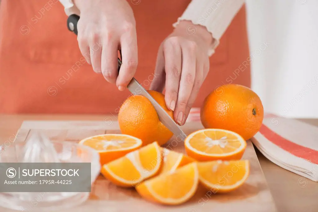 Woman cutting oranges