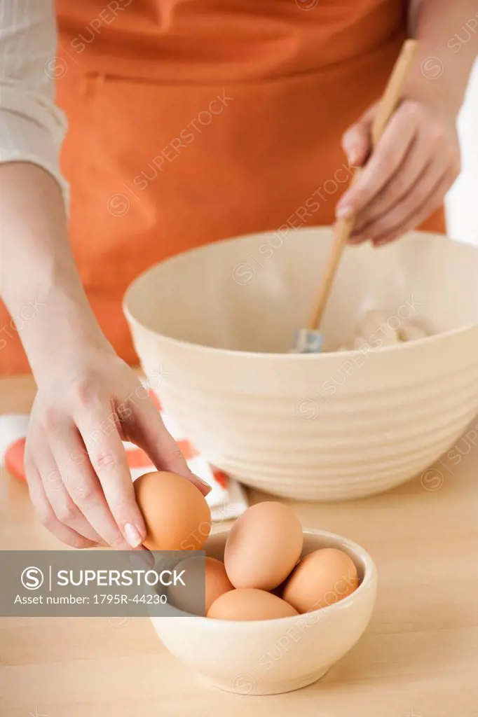 Woman preparing dough in bowl