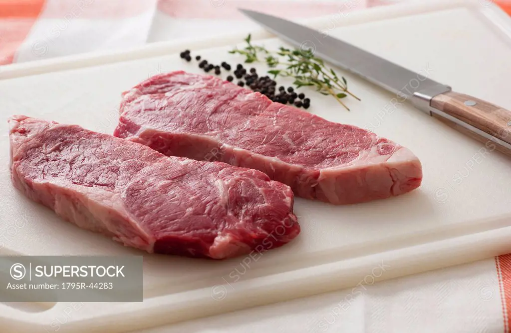 Studio shot of raw steak on chopping board