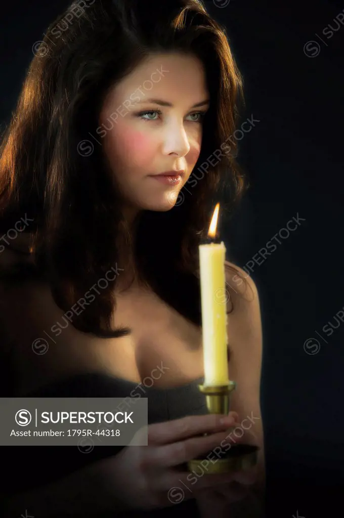 Young woman holding candle