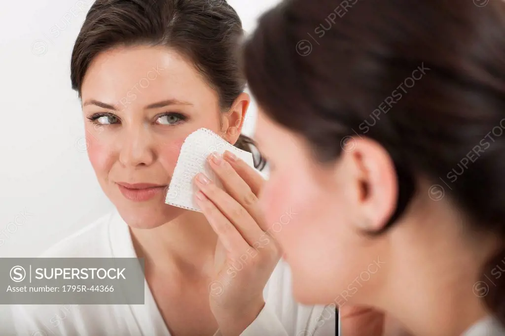 USA, New Jersey, Jersey City, woman removing make_up in bathroom