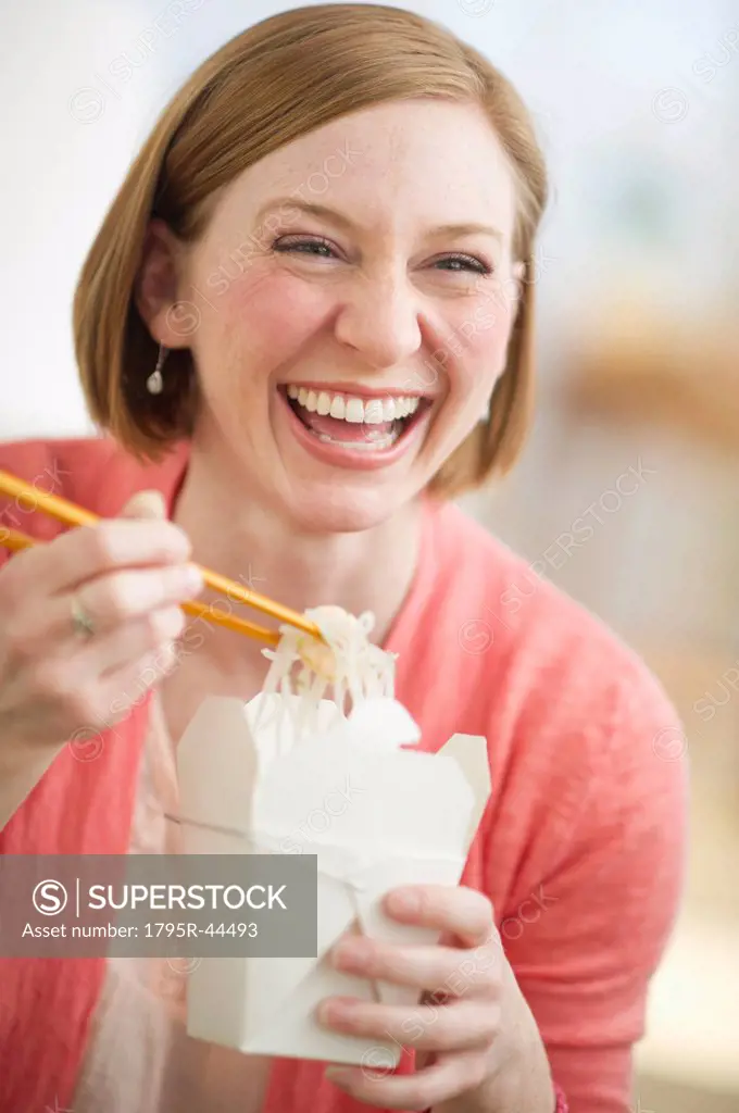 USA, New Jersey, Jersey City, woman eating Chinese take out food