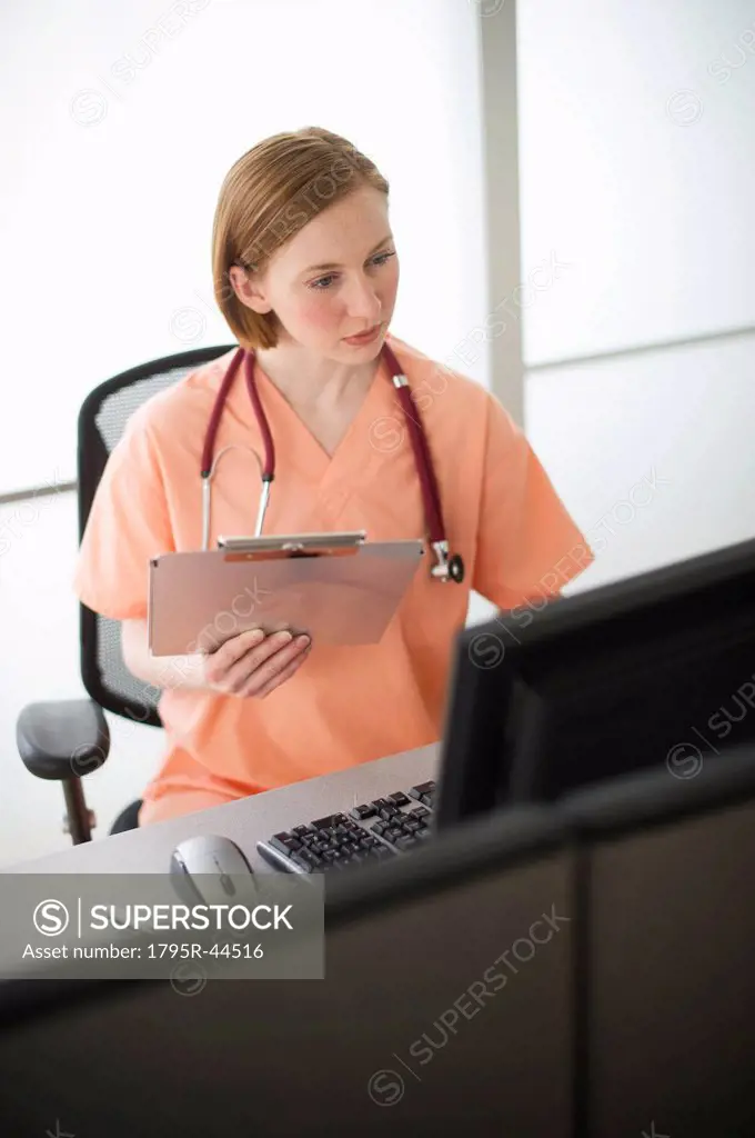 USA, New Jersey, Jersey City, female nurse reading medical records