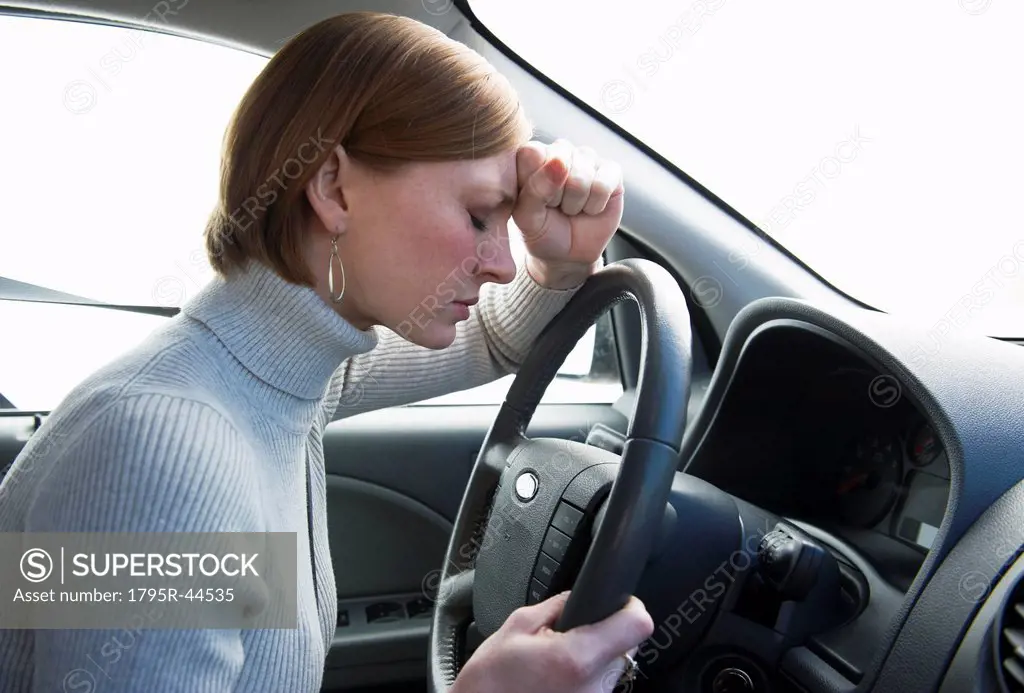 USA, New Jersey, Jersey City, woman driving car looking upset