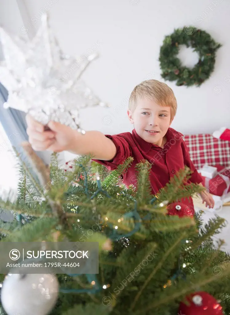 Boy 8_9 decorating Christmas tree