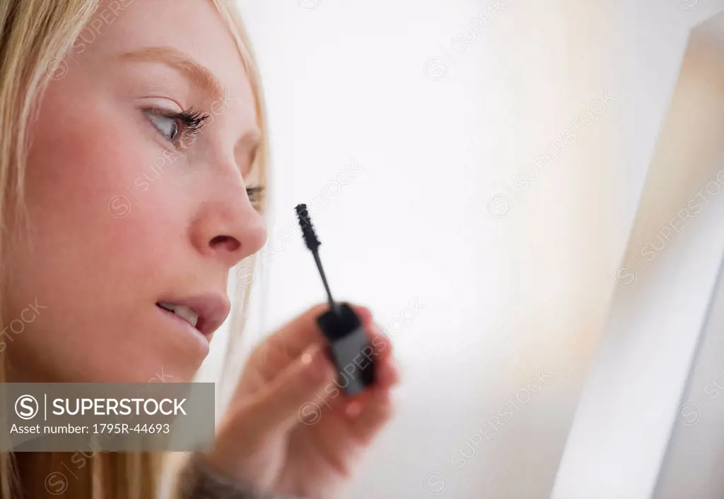 Jersey City, New Jersey, young woman applying mascara