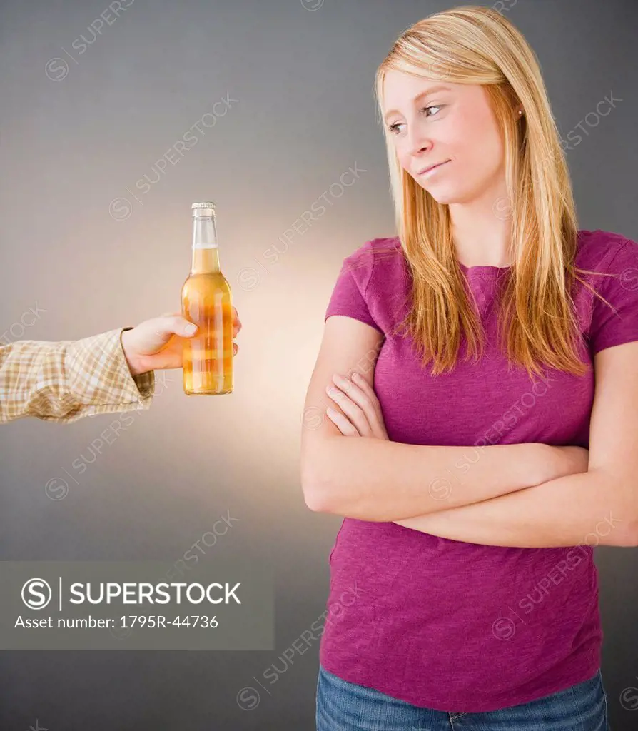 Young woman being offered beer