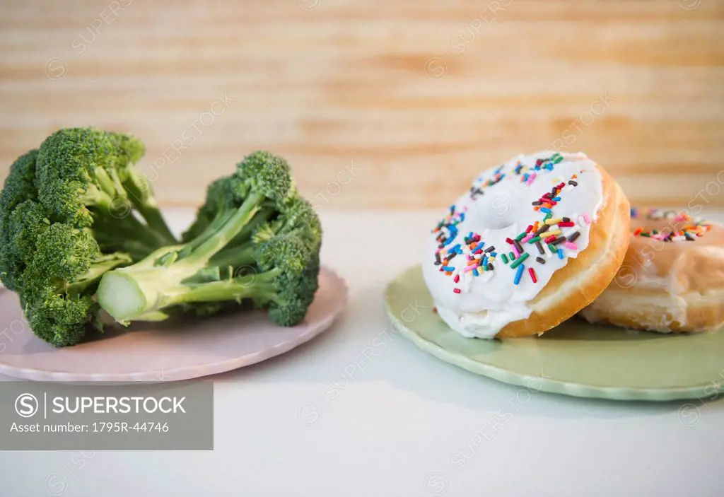 USA, New Jersey, Jersey City, donuts against broccoli
