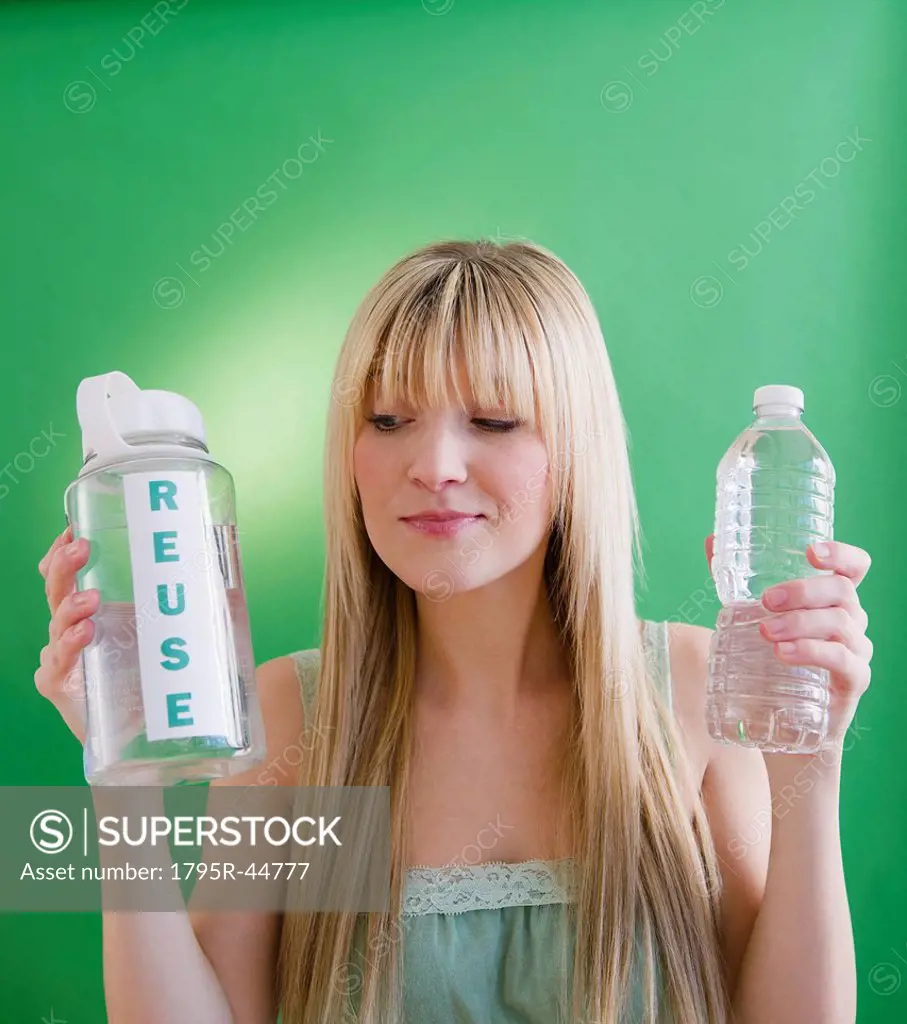 Young woman holding plastic bottles