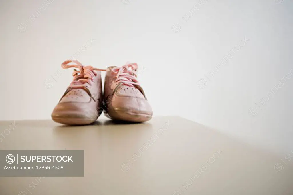 Pair of baby shoes on table