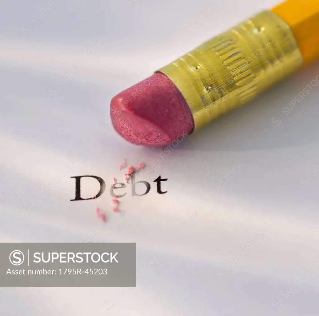 Studio shot of pencil erasing the word debt from piece of paper