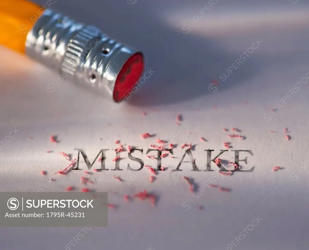 Studio shot of pencil erasing the word mistake from piece of paper