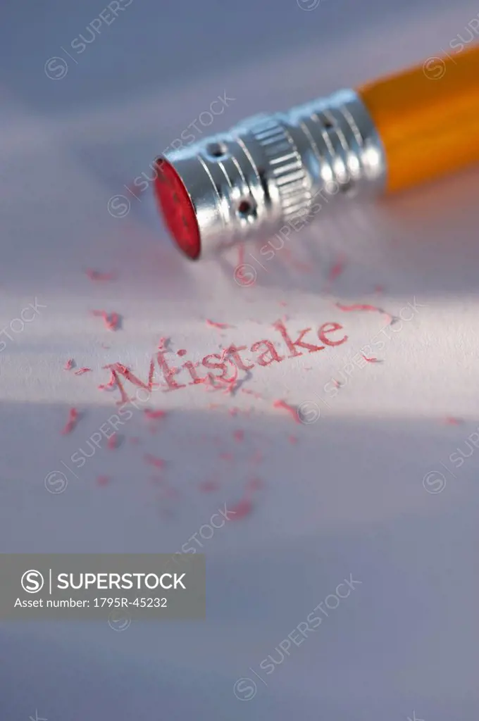 Studio shot of pencil erasing the word mistake from piece of paper