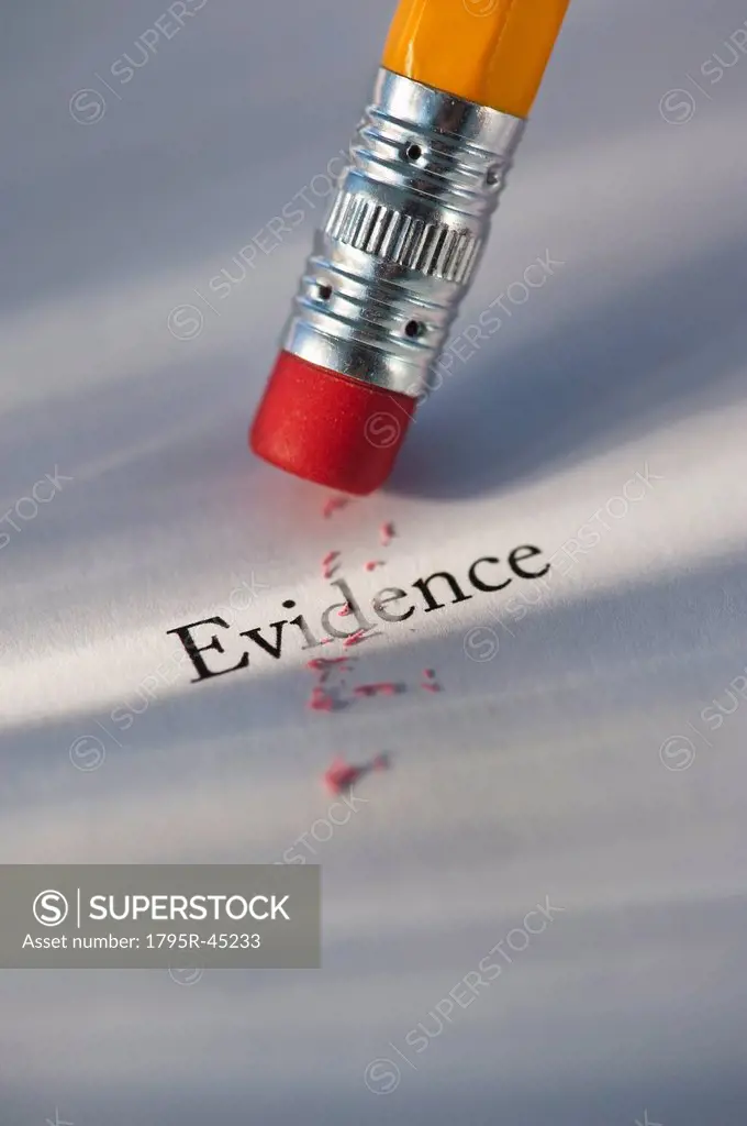 Studio shot of pencil erasing the word evidence from piece of paper