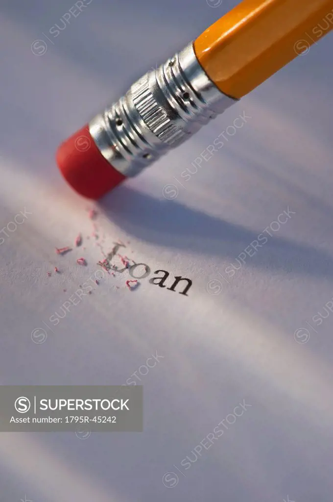 Studio shot of pencil erasing the word loan from piece of paper