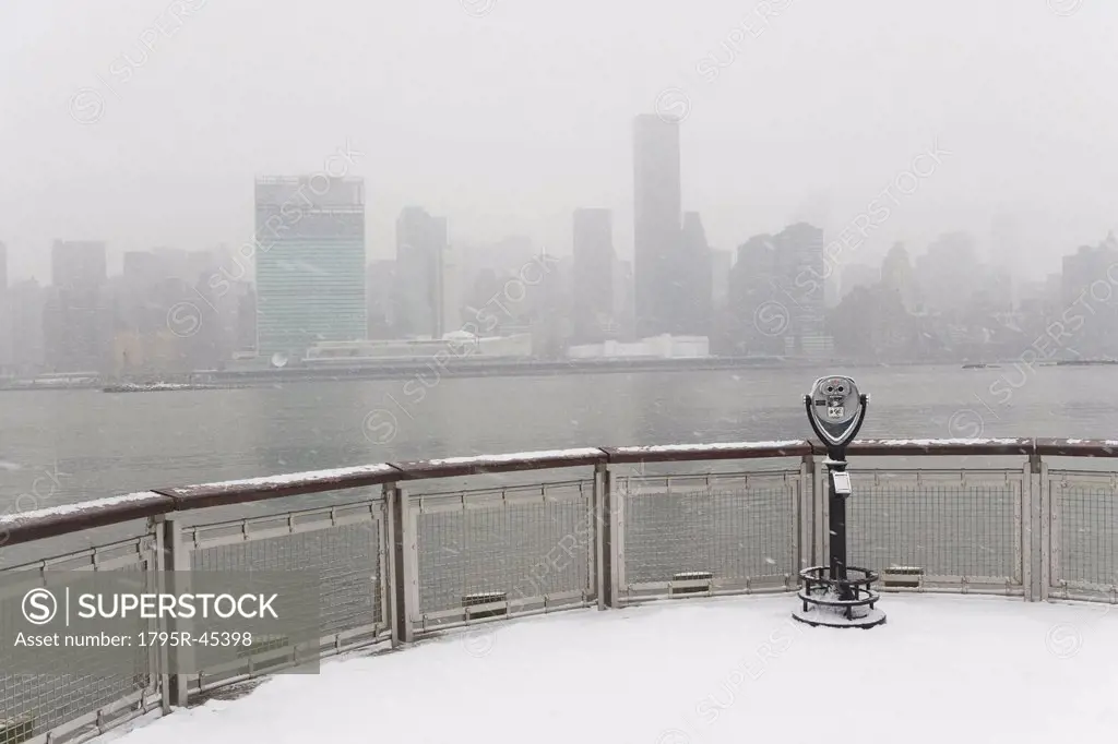 USA, New York City, coin operated binoculars overlooking foggy Manhattan