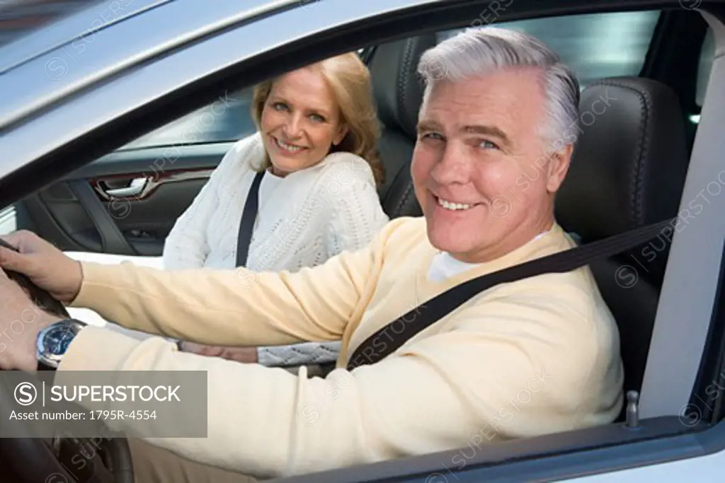 Senior couple driving in car