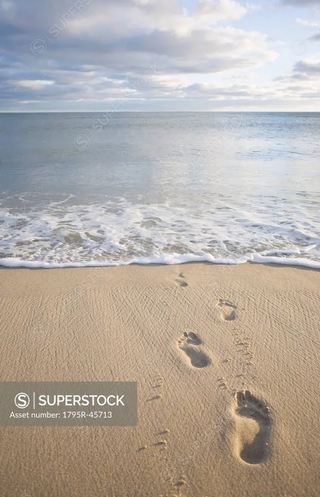 USA, Massachusetts, Cape Cod, footprints on beach at sunset