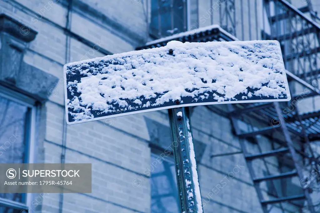 USA, New York City, Arrow sign covered with snow