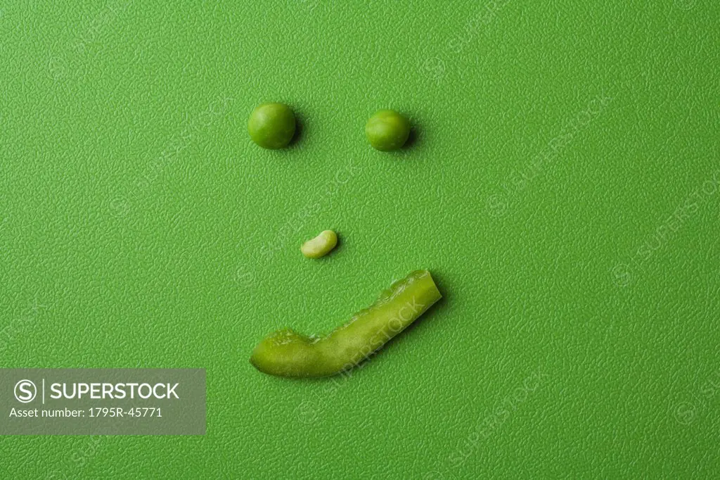 Anthropomorphic face made up from green peas