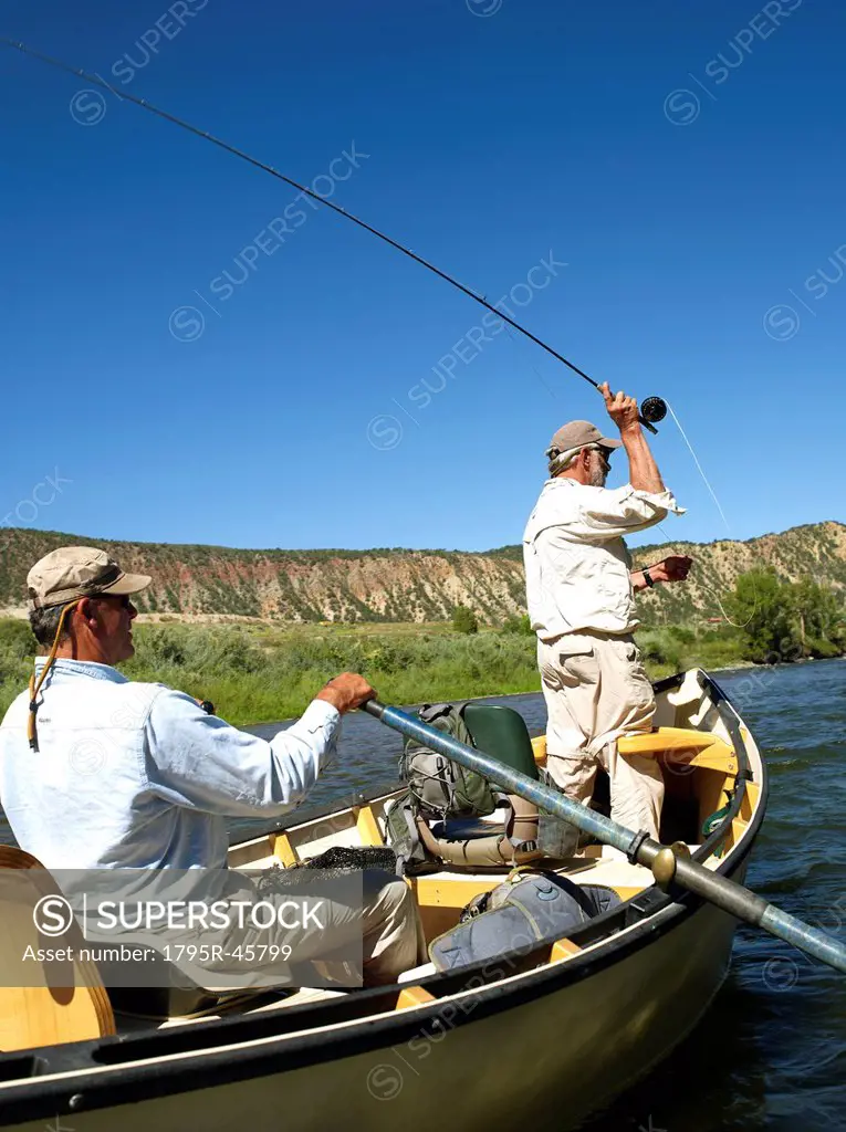 USA, Colorado, Pair of men fly_fishing on mountain river