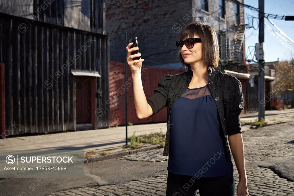 USA, New York City, Brooklyn, woman in street using phone