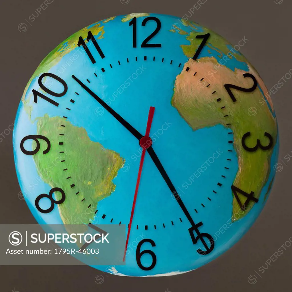 Studio Shot of clock embedded in globe