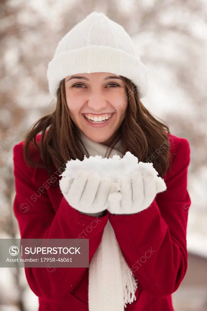 USA, Utah, Lehi, Portrait of young woman holding snow