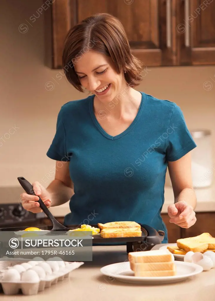 Woman preparing breakfast in kitchen